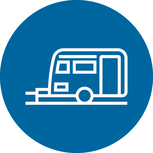 An icon of a travel trailer in a blue circle.